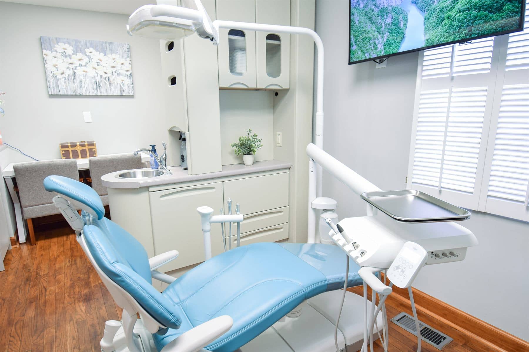 A treatment room with the patient chair and entertainment screen