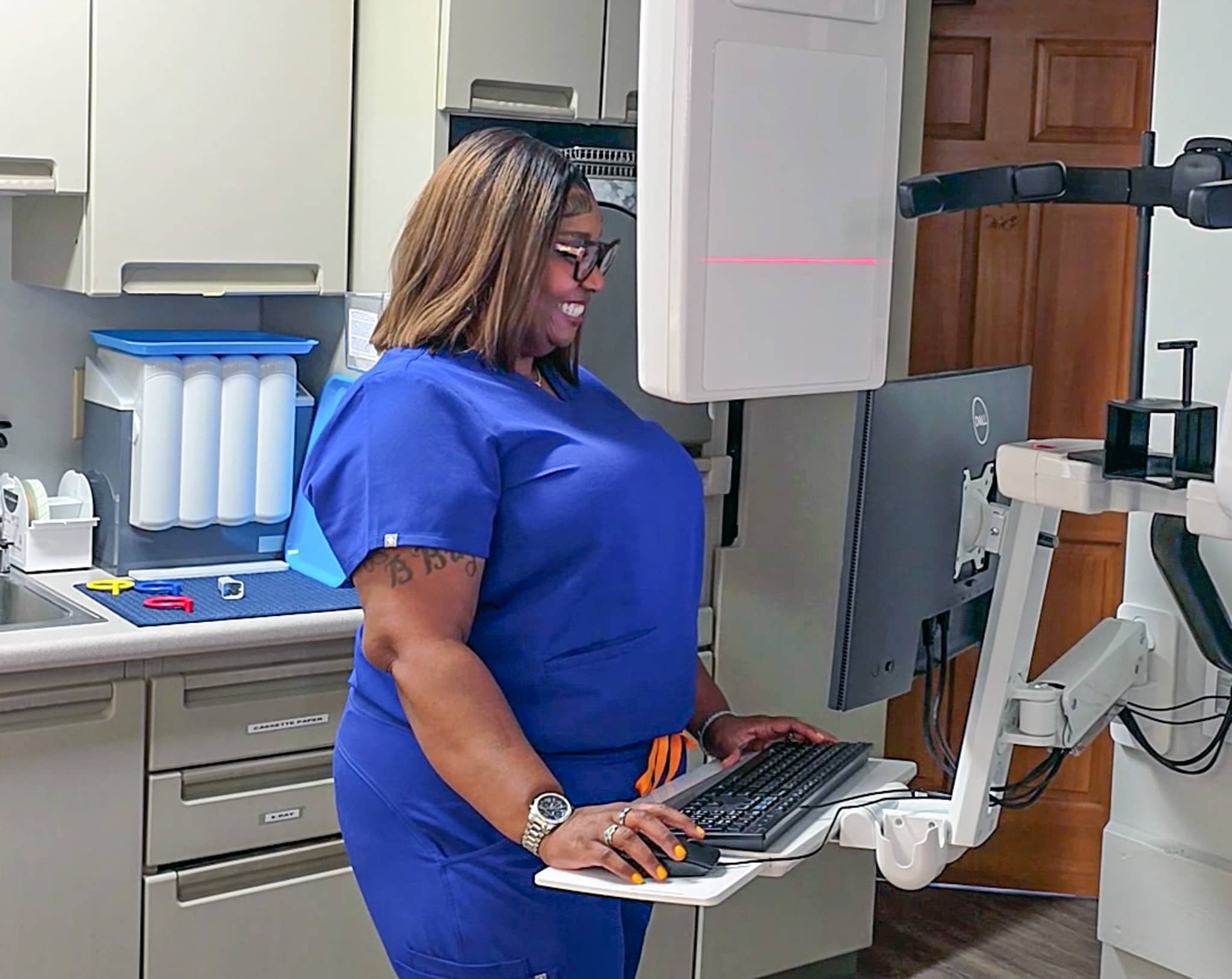 A team member capturing panoramic X-rays